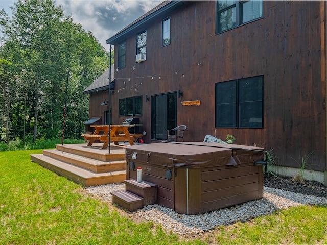 back of property featuring a wooden deck, a hot tub, cooling unit, and a yard