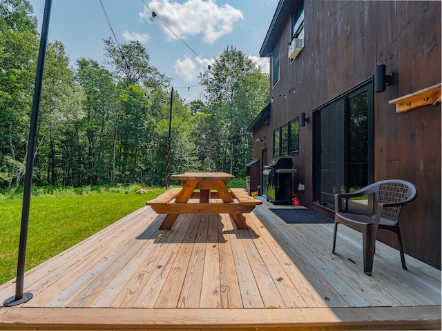 wooden deck featuring grilling area and a yard