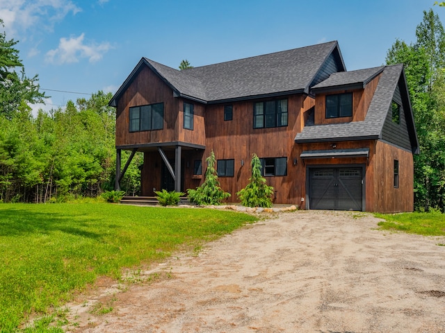 view of front of house with a front yard and a garage