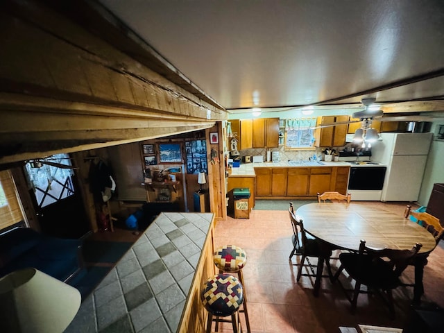 dining room featuring ceiling fan and sink