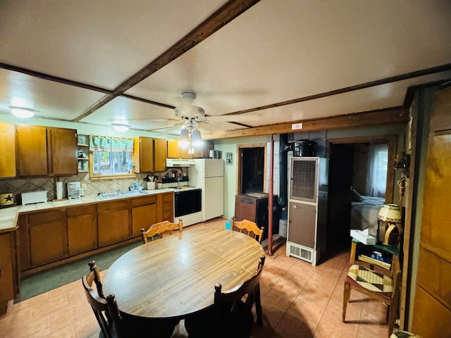 dining area with ceiling fan and sink