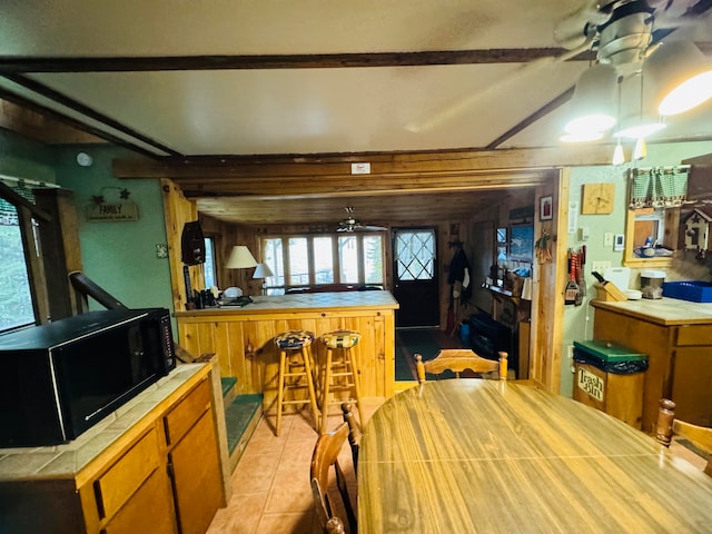 dining room featuring bar area and light tile patterned floors