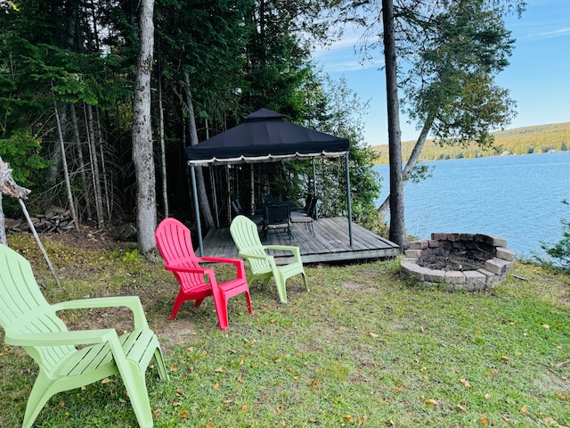 view of yard featuring a gazebo and a deck with water view