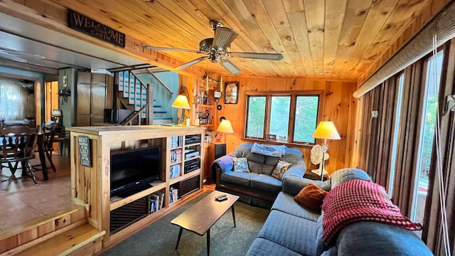 living room with wood walls, wooden ceiling, vaulted ceiling, and ceiling fan