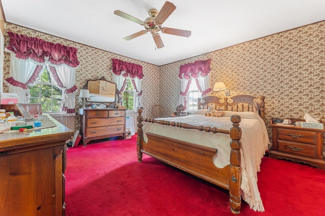 carpeted bedroom featuring ceiling fan and multiple windows