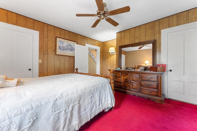 bedroom with wooden walls, carpet, and ceiling fan