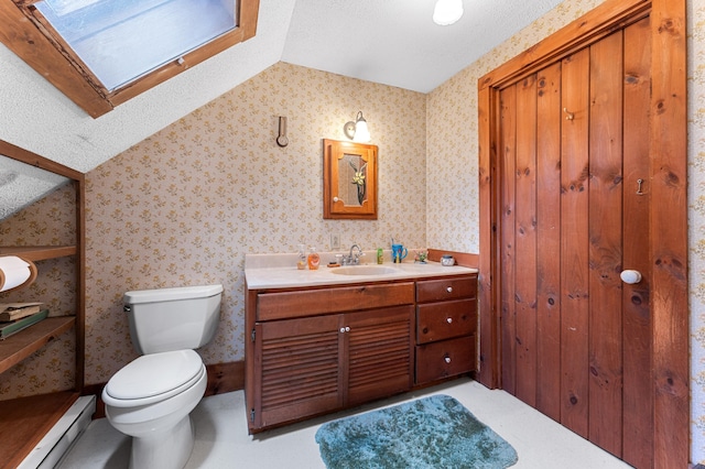 bathroom featuring a baseboard radiator, vanity, lofted ceiling with skylight, and toilet