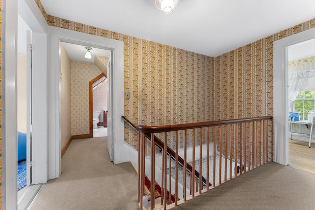 hallway with light colored carpet