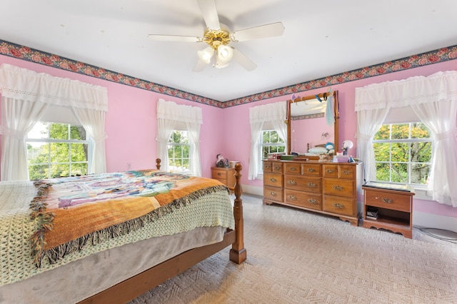 bedroom with carpet flooring, multiple windows, and ceiling fan