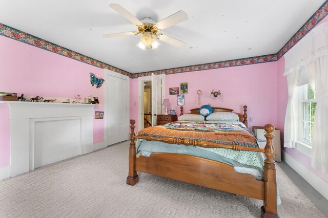 bedroom featuring a closet, ceiling fan, and light colored carpet