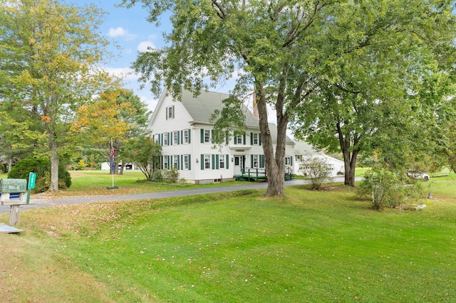 rear view of property featuring a yard