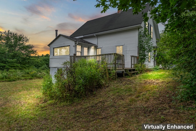 property exterior at dusk with a deck