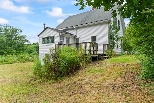 back of house featuring a deck