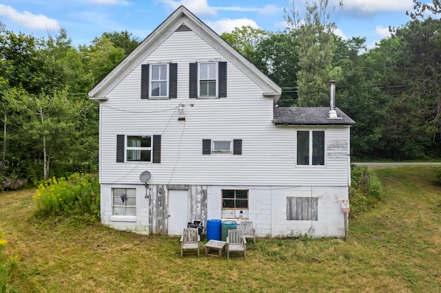 back of house with a lawn