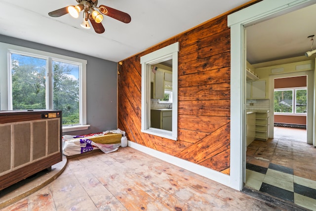 interior space with ceiling fan