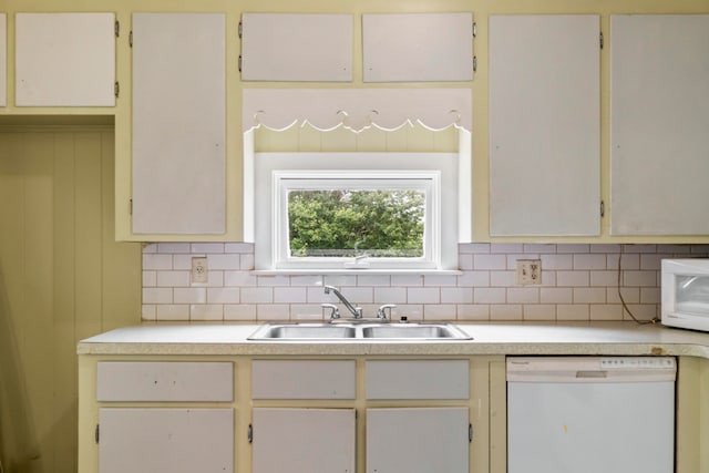 kitchen with sink, white appliances, and decorative backsplash