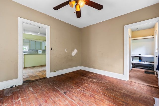 spare room featuring ceiling fan and hardwood / wood-style flooring