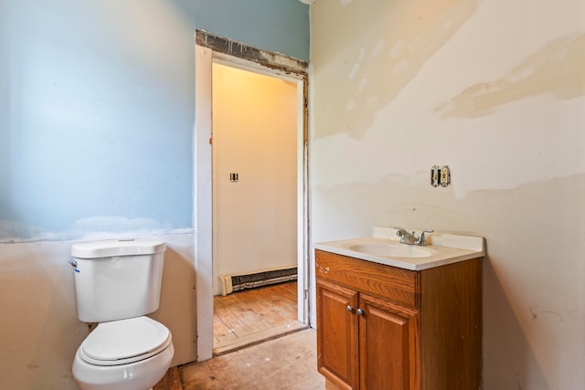 bathroom with vanity, toilet, and hardwood / wood-style flooring