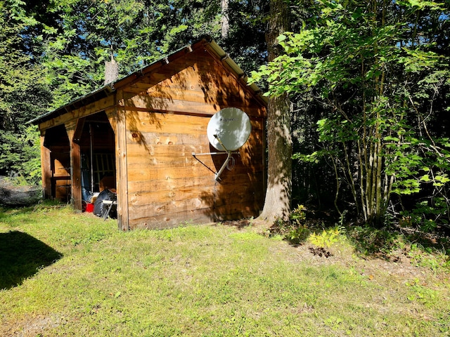 view of outbuilding with a yard