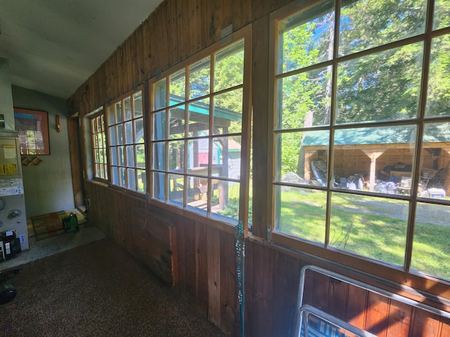 unfurnished sunroom featuring vaulted ceiling