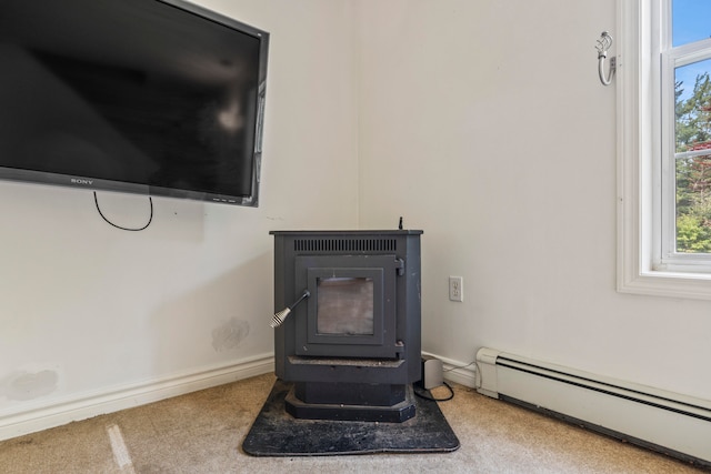 room details with carpet flooring, a wood stove, and a baseboard heating unit