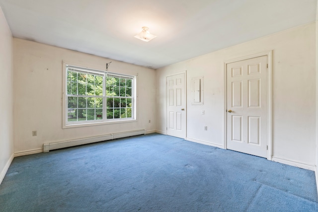 unfurnished bedroom with carpet flooring, two closets, and a baseboard radiator