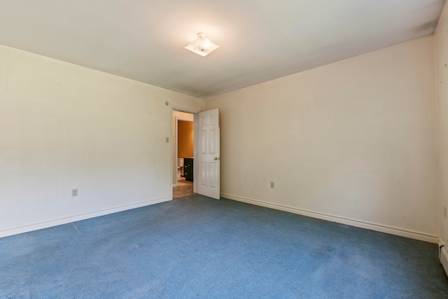 empty room featuring dark colored carpet