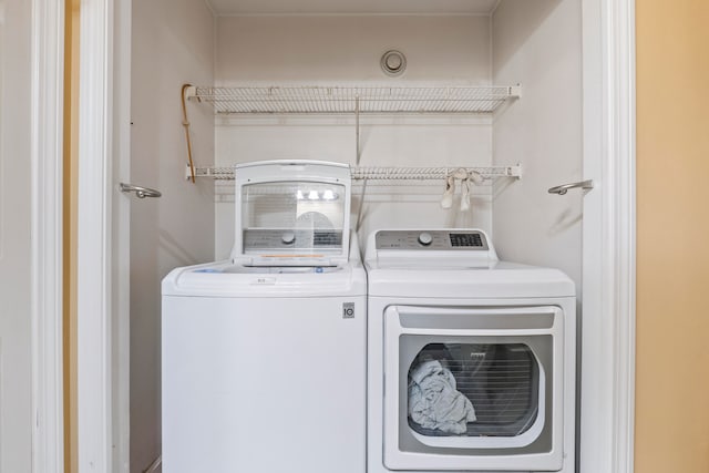 washroom with separate washer and dryer