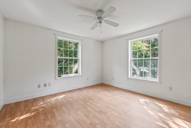 spare room featuring ceiling fan, plenty of natural light, and light hardwood / wood-style floors