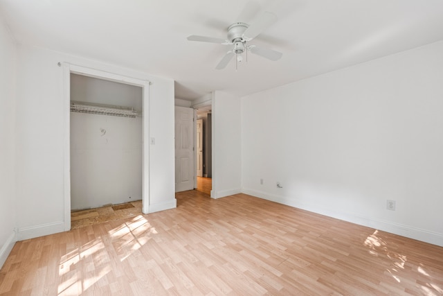 unfurnished bedroom featuring light hardwood / wood-style floors, ceiling fan, and a closet