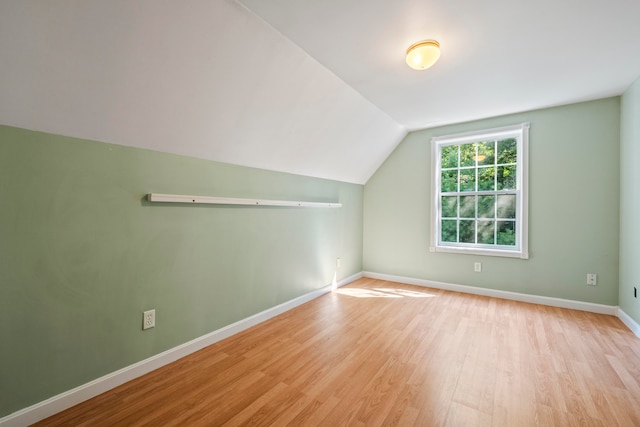 bonus room with light hardwood / wood-style flooring and vaulted ceiling