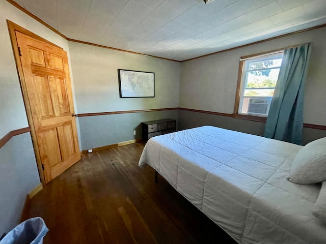 bedroom with ornamental molding and dark wood-type flooring