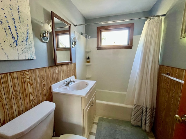 full bathroom featuring wooden walls, vanity, toilet, and shower / bath combination with curtain