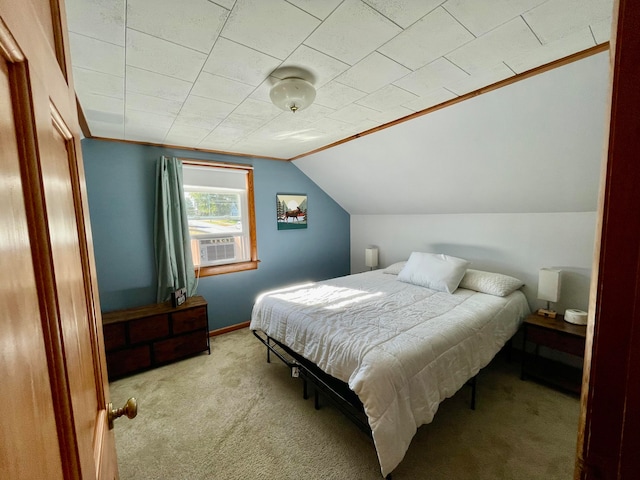 bedroom with cooling unit, light colored carpet, and lofted ceiling