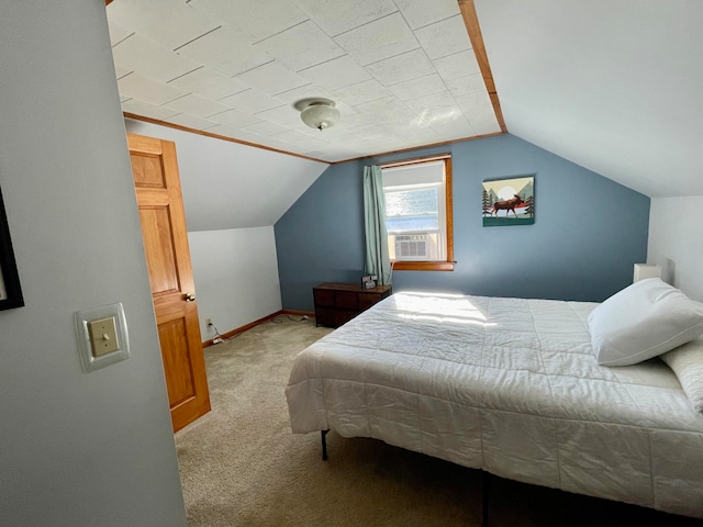 bedroom with light carpet, cooling unit, and vaulted ceiling