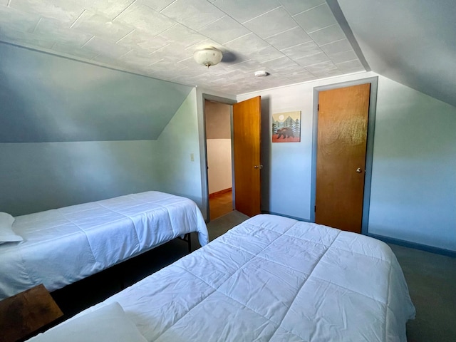 carpeted bedroom featuring lofted ceiling