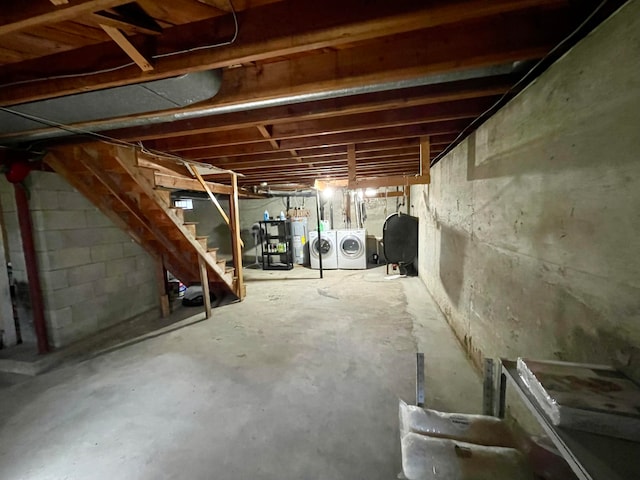 basement featuring water heater and washing machine and dryer