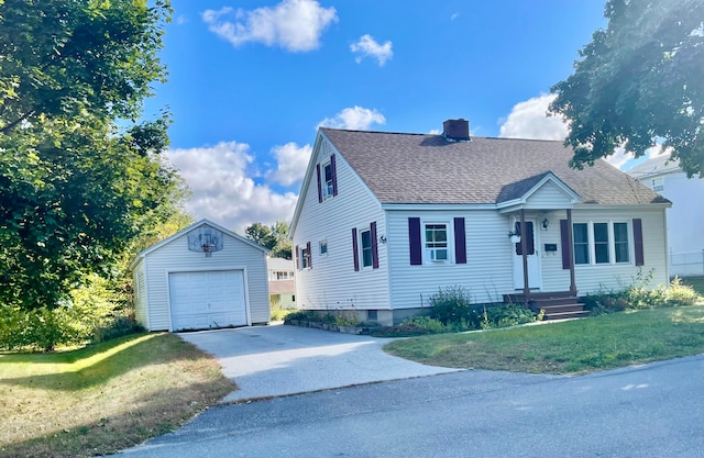 view of front of house featuring an outdoor structure, a garage, and a front lawn