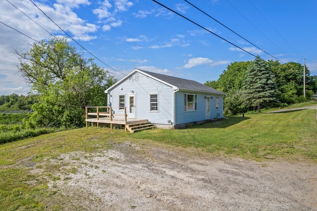 view of side of property with a yard and a wooden deck