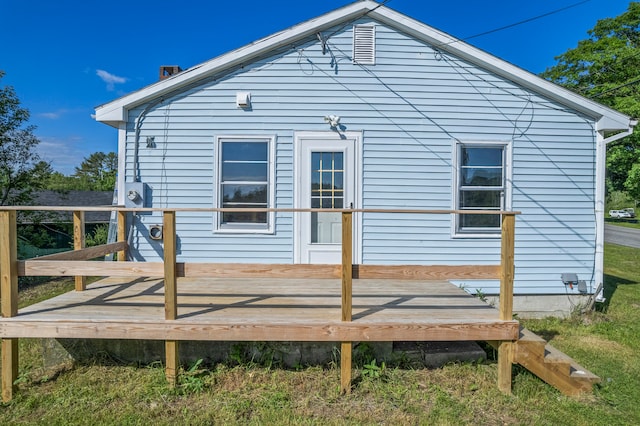 rear view of property featuring a deck