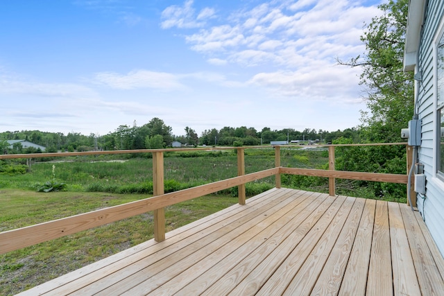 wooden terrace with a lawn