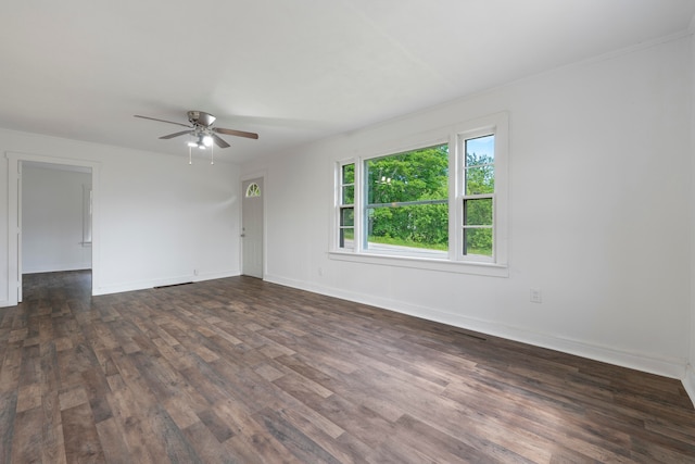 spare room with dark wood-type flooring and ceiling fan