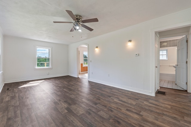 spare room with crown molding, dark hardwood / wood-style floors, and ceiling fan