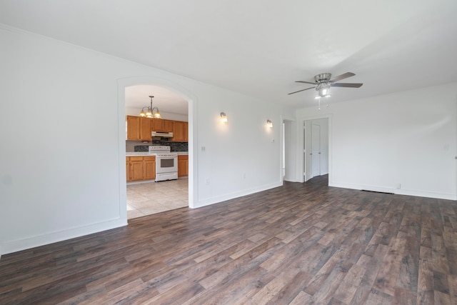 spare room featuring light hardwood / wood-style flooring and ceiling fan with notable chandelier