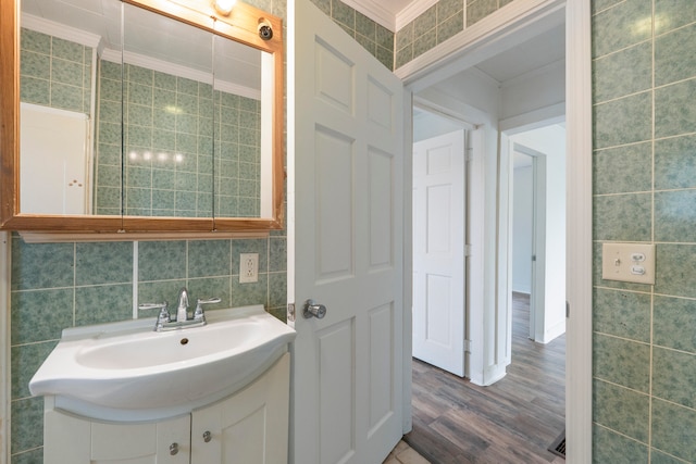 bathroom with vanity, hardwood / wood-style flooring, and tile walls