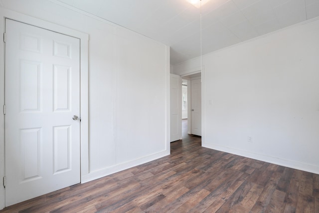 empty room featuring dark wood-type flooring