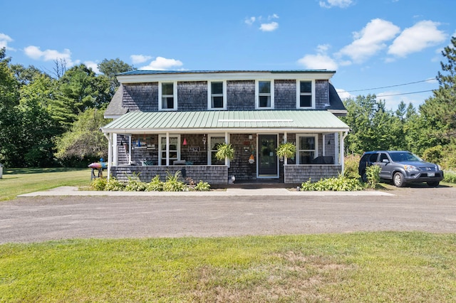 view of front of property with a porch and a front yard