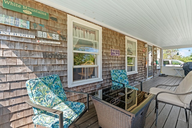 wooden terrace featuring covered porch