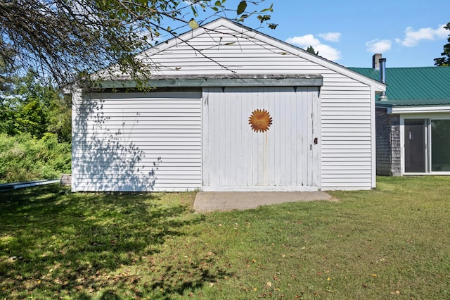 view of outbuilding featuring a yard