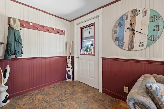 interior space featuring wooden walls and ornamental molding